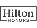 The image shows the Hilton Honors logo, featuring the words "Hilton Honors" in a rectangular box. logo on footer section.